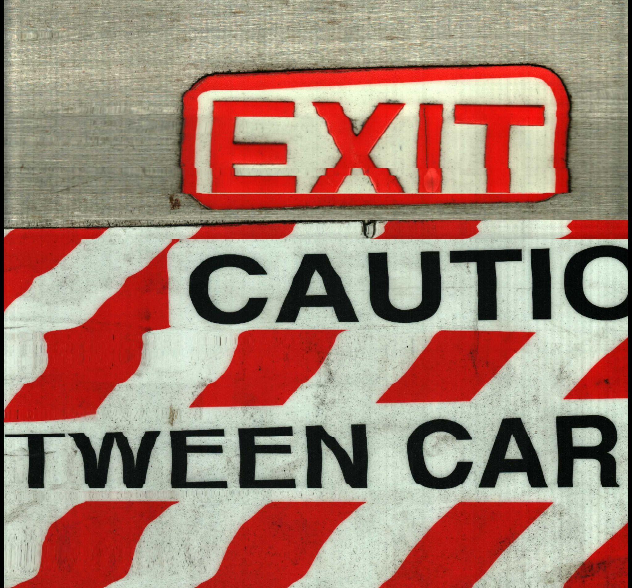 Red exit and caution signage